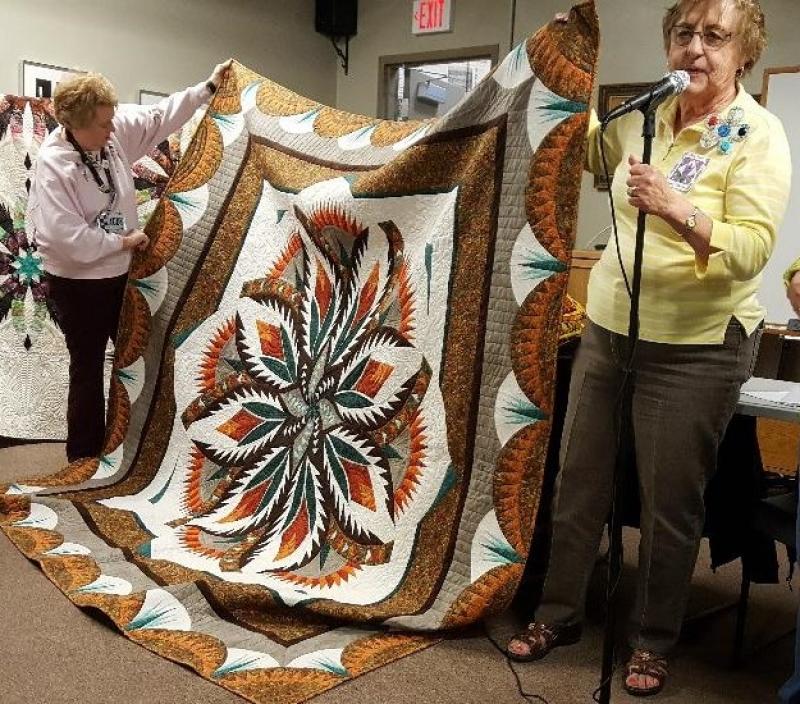 Patsy and Irene have made the same pattern quilt but in different colors
